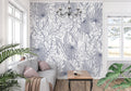 Blue tropical line art wallpaper in modern living room with white sofa and natural light