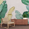 Tropical banana leaf wallpaper creating a fresh modern atmosphere in a bright living room with natural light