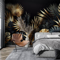 Tropical black and gold leaf wallpaper creating drama in a modern living room with evening lighting