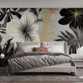 Black and gold tropical wallpaper mural creating a stunning backdrop in a modern dining room with ambient lighting