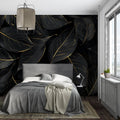 Black and gold leaf wallpaper in modern dining room with pendant lights highlighting metallic details