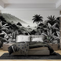 Black and white tropical jungle mural wallpaper creating depth in a modern living room with minimalist furniture