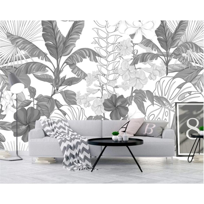 Monochrome tropical wallpaper creating drama in a contemporary dining room space