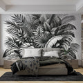 Tropical Monstera leaf wallpaper in modern minimalist living room, black and white design creating dramatic focal point