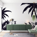 Black and white tropical palm wallpaper creating a dramatic feature wall in a modern living room with minimal furniture