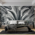Black and white palm leaves wallpaper creating a modern statement wall in a bright living room setting