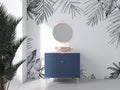 Black and white tropical palm leaf wallpaper in a bright modern living room setting with minimal furniture