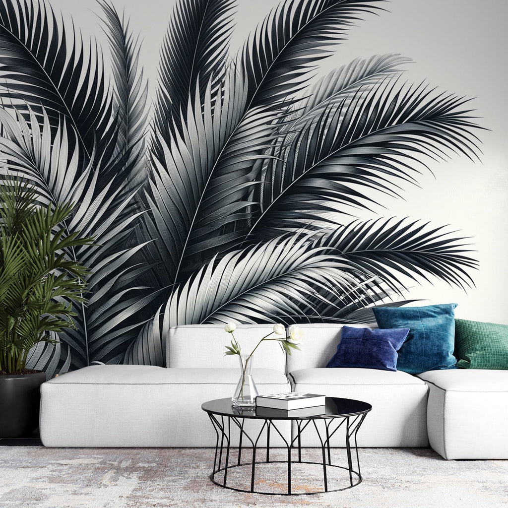 Black and white tropical palm leaf wallpaper creating drama in a modern minimalist living room with natural light
