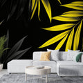 Tropical leaf wallpaper with yellow palm leaves on black background showcased in a modern living room setting