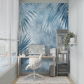 Blue Palm Leaves Mural Wallpaper in bright modern living room with white sofa and natural light
