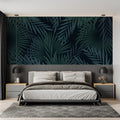 Tropical palm leaves wallpaper in modern living room with black sofa and natural light