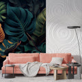 Dark Monstera leaf wallpaper in modern living room with gray sofa and natural light