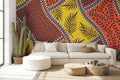 Tropical geometric leaf wallpaper brightening a modern living room with orange and yellow tones