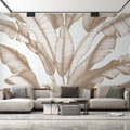 Tropical leaf wallpaper with beige banana leaves creating a calm atmosphere in a modern living room with natural light