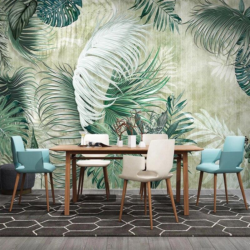 Bedroom with green monstera leaf wallpaper showing natural light and plant pattern