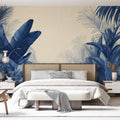 Tropical palm leaf wallpaper in navy blue creating a stunning accent wall in a modern living room with natural light