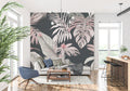 Pink and grey Monstera leaf wallpaper in a modern living room creating a calm, sophisticated atmosphere