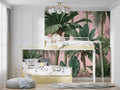 Tropical palm leaf wallpaper in modern living room showing pink and green color harmony