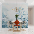 Tropical palm leaf wallpaper in modern living room showing soft blue botanical pattern creating peaceful atmosphere