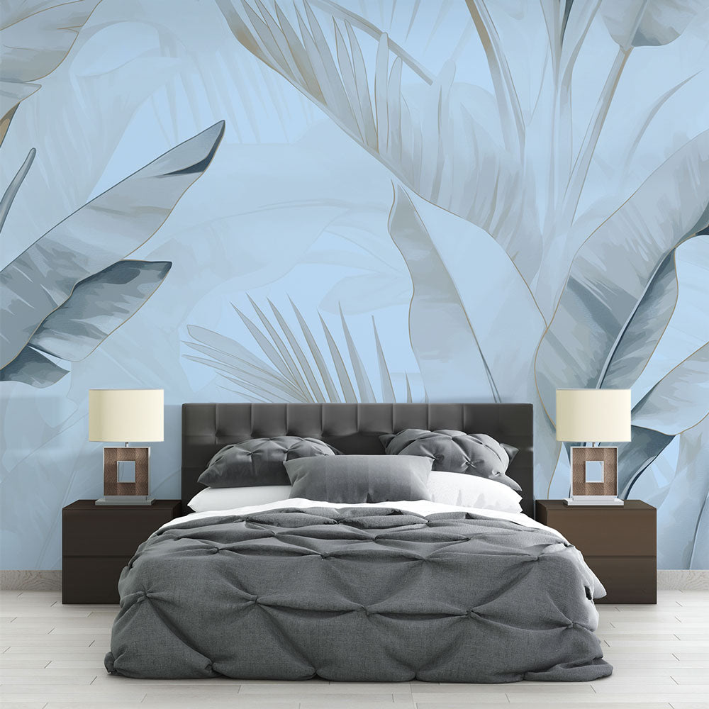 Tropical palm leaf wallpaper in blue tones creating a serene atmosphere in a modern living room with natural light