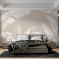 Tropical banana leaf wallpaper in modern living room, white leaves on beige creating a bright, airy atmosphere