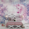 Pink unicorn wallpaper mural in a bright nursery with white furniture