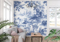 Blue Toile de Jouy wallpaper in elegant dining room with crystal chandelier and white wainscoting