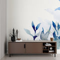 Blue watercolor floral wallpaper in a bright modern living room creating a peaceful atmosphere