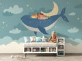 Whale wallpaper mural creating magic in a modern nursery with soft lighting and wooden furniture
