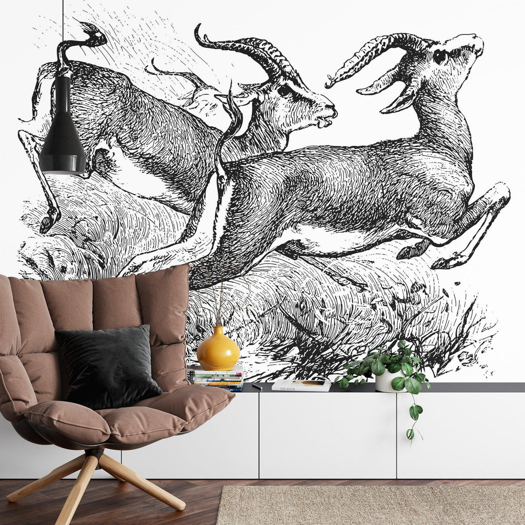 Black and white gazelle sketch mural adding drama to dining room with wooden table and pendant lights