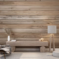 Pine plank wallpaper creating a warm atmosphere in a modern living room with grey sofa and plants