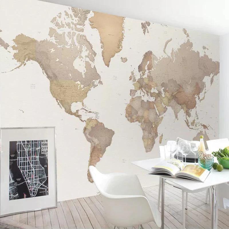 Modern World Map Wallpaper displayed in a bright home office, showing beige continents against white background