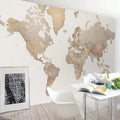 Modern World Map Wallpaper displayed in a bright home office, showing beige continents against white background