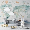 World map wallpaper with watercolor animals in bright modern nursery, creating an educational play space